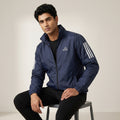 Men's navy blue lightweight windbreaker jacket with full-zip closure, high collar and contrasting sleeve detailing.